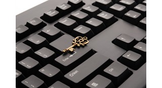 computer keyboard with a gold key resting on the enter key