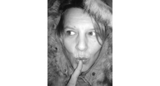 Person making a shushing gesture.
